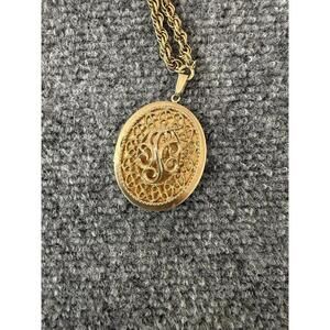 Vintage Signed Sarah Coventry large locket/pendant /w scroll work on gold chain.